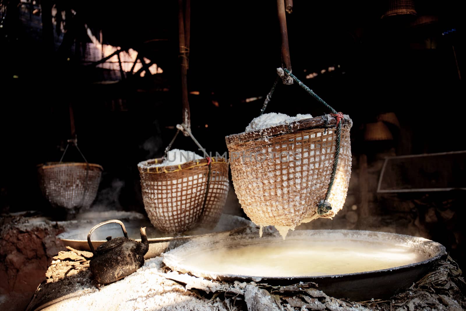 Salt basket hanging on fireplace in the countryside.