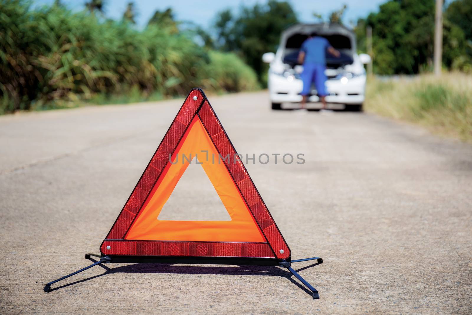 Emergency signs on road because of broken cars in the countryside.