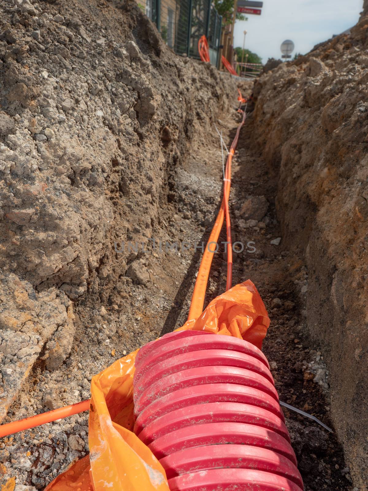 Data fiber optic cables in ribbed pipe under road by rdonar2