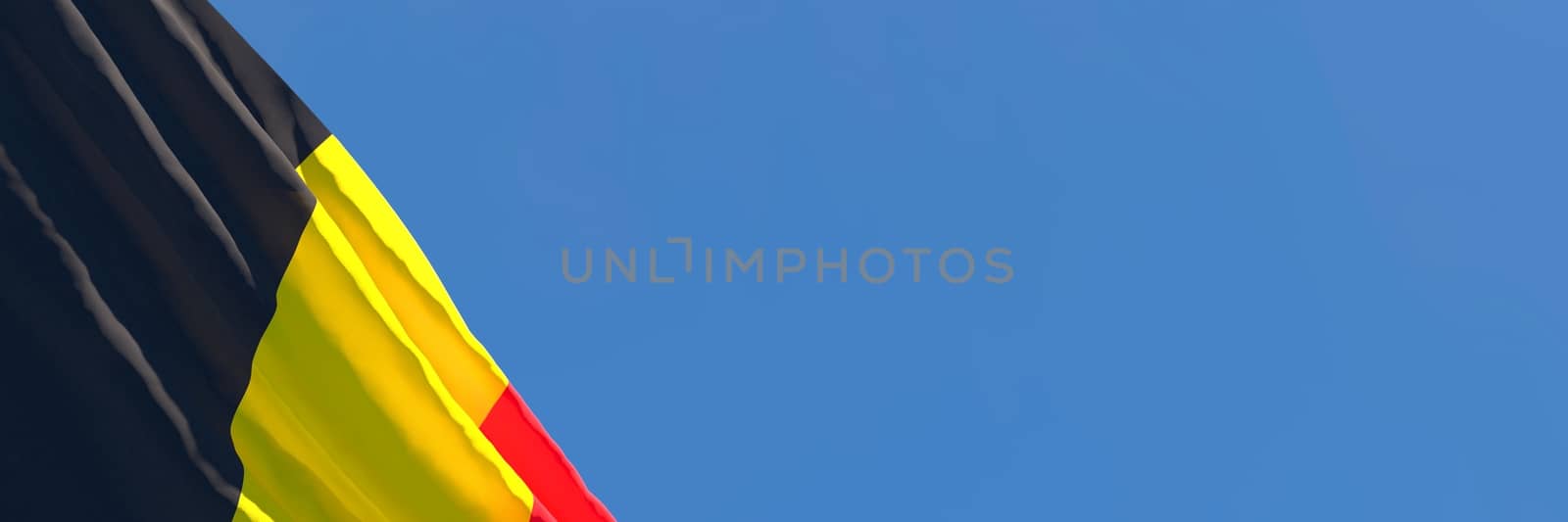 3D rendering of the national flag of Belgium waving in the wind against a blue sky