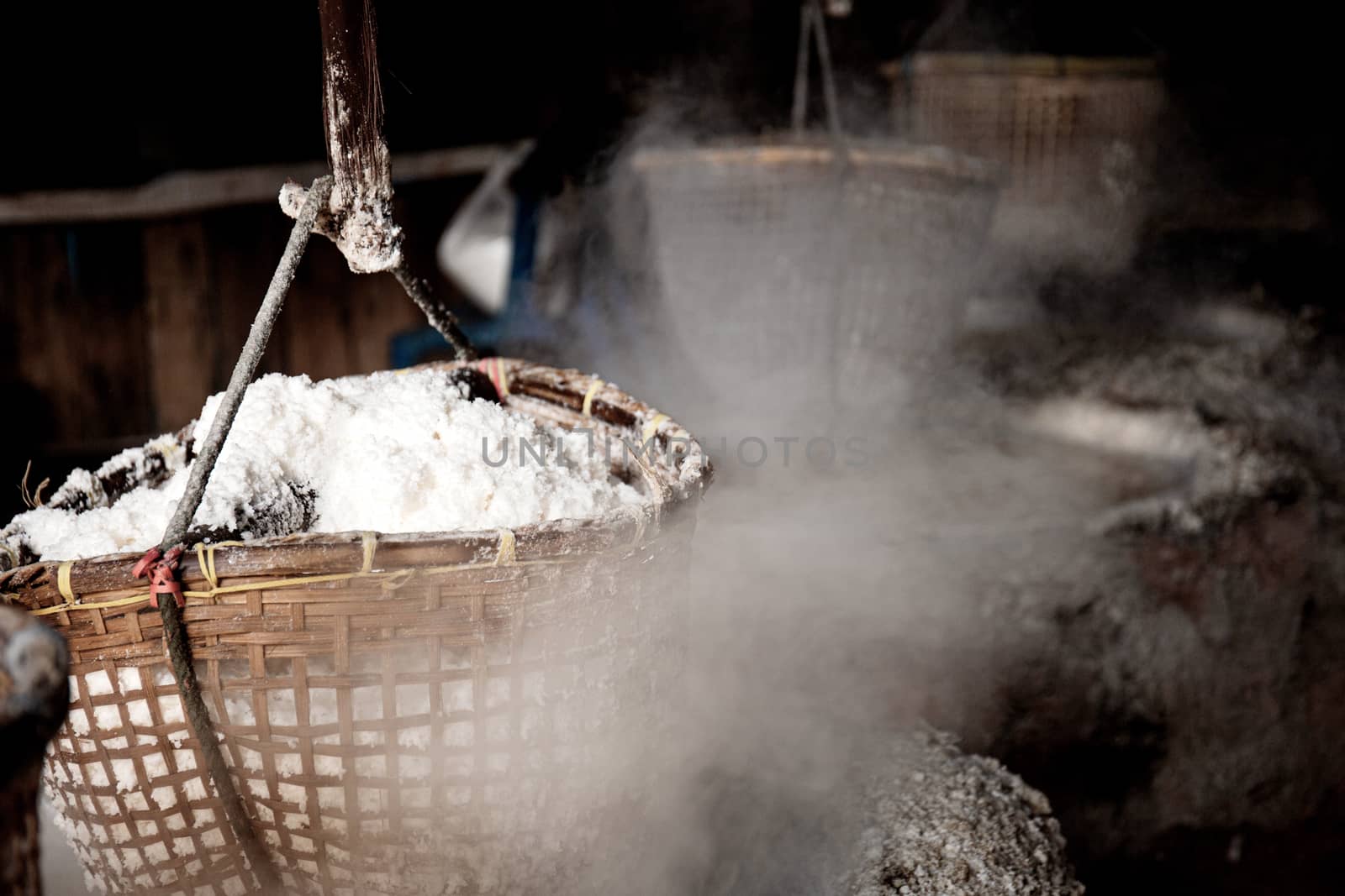 Smoke of fireplace with salt basket hanging in Thailand.