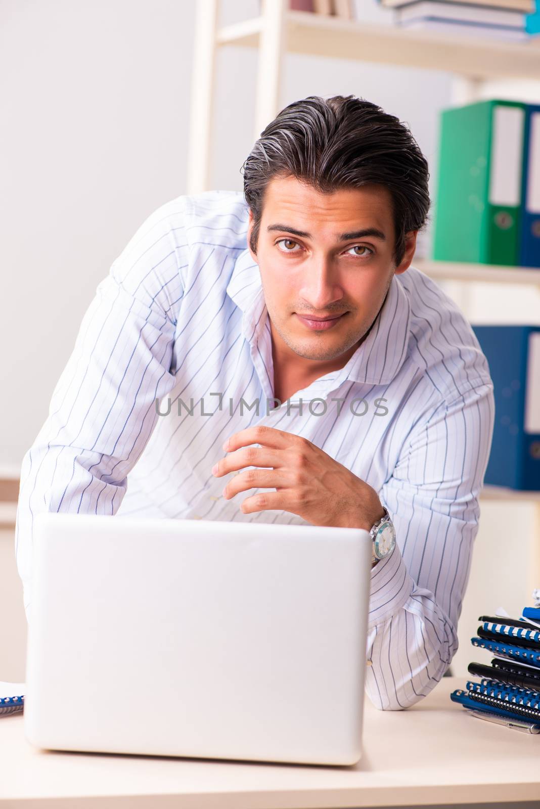 Young employee sitting at the office 