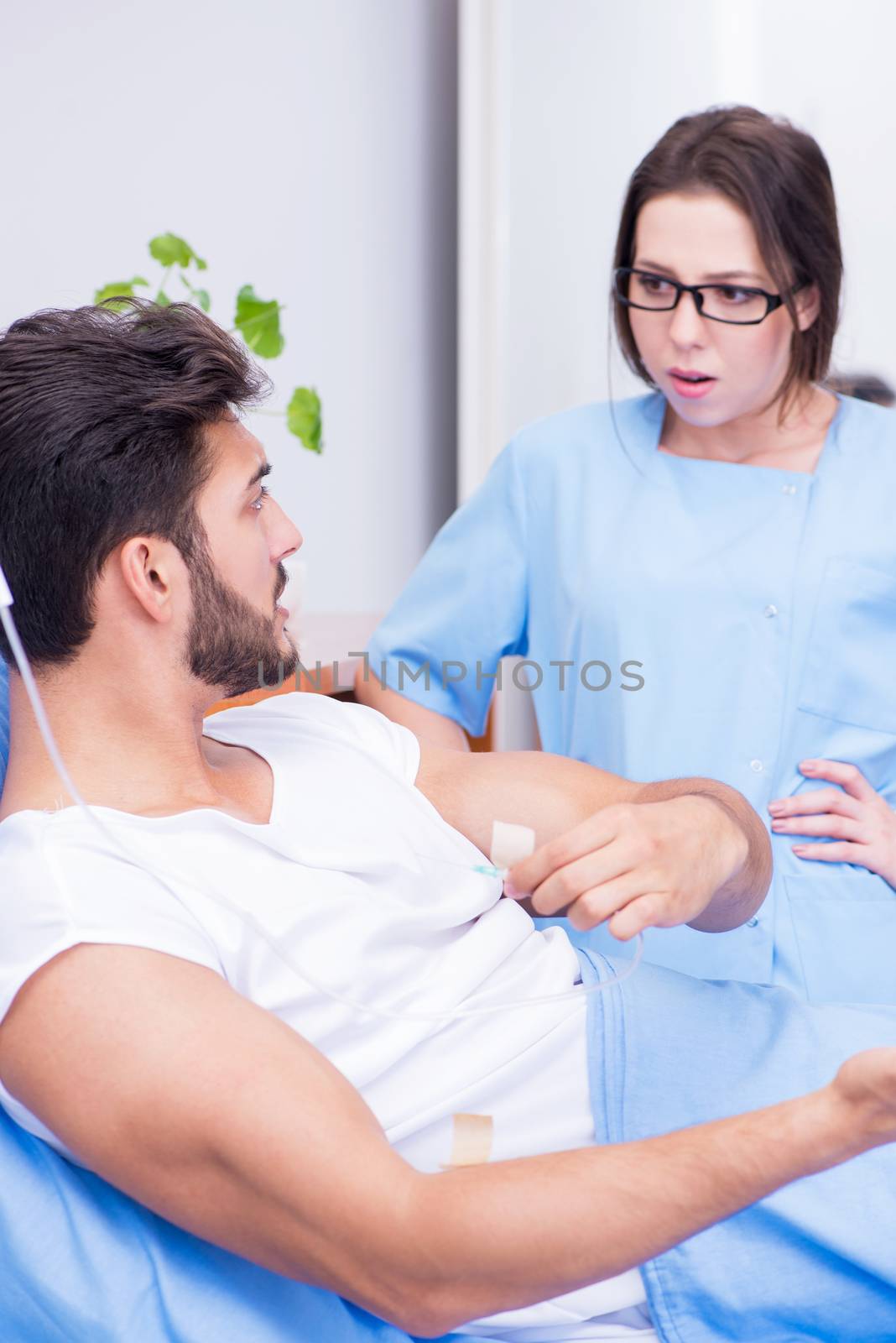 Woman doctor examining male patient in hospital