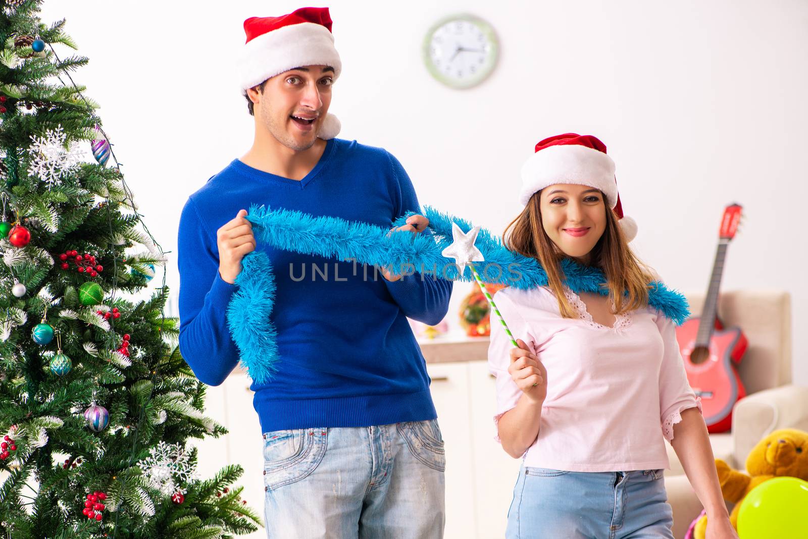 Young family celebrating christmas at home