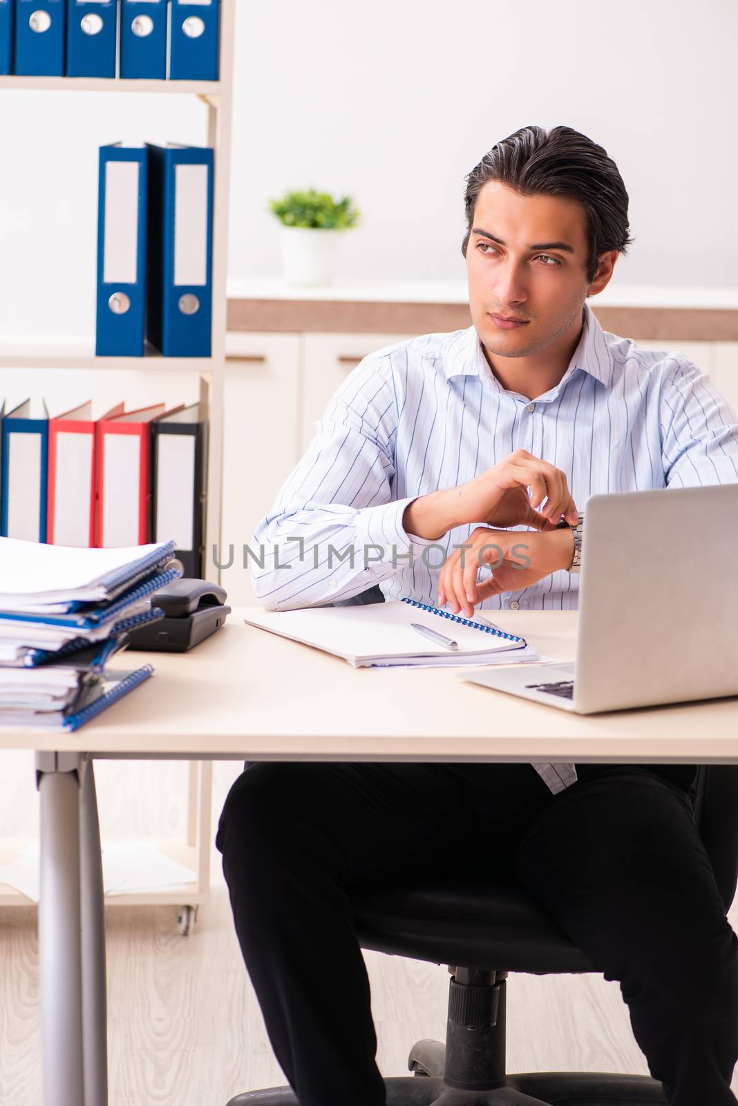 Young employee sitting at the office 