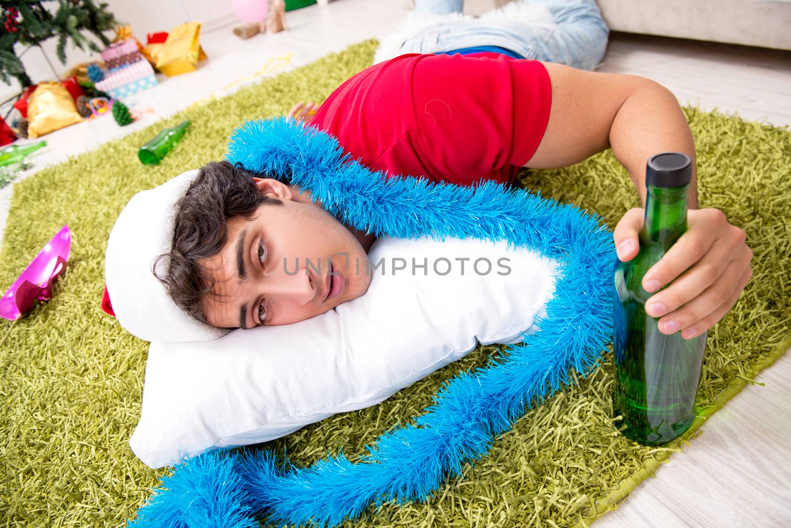 Young man drunk at home after christmas party