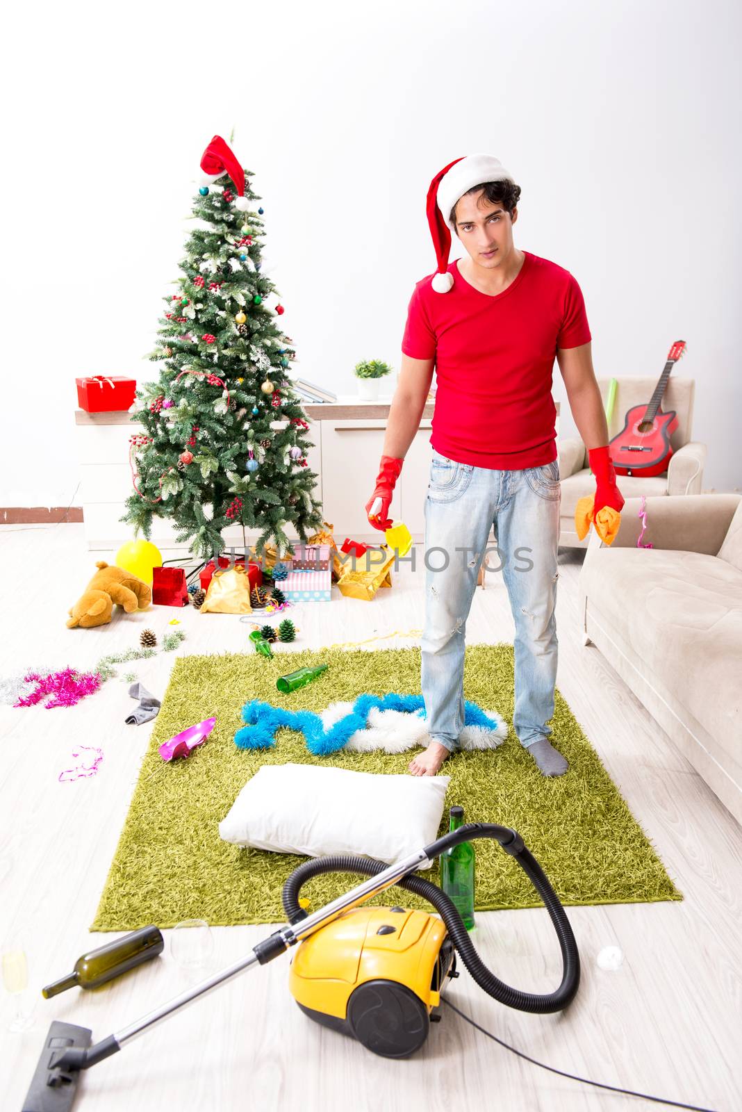 Man cleaning his apartment after christmas party