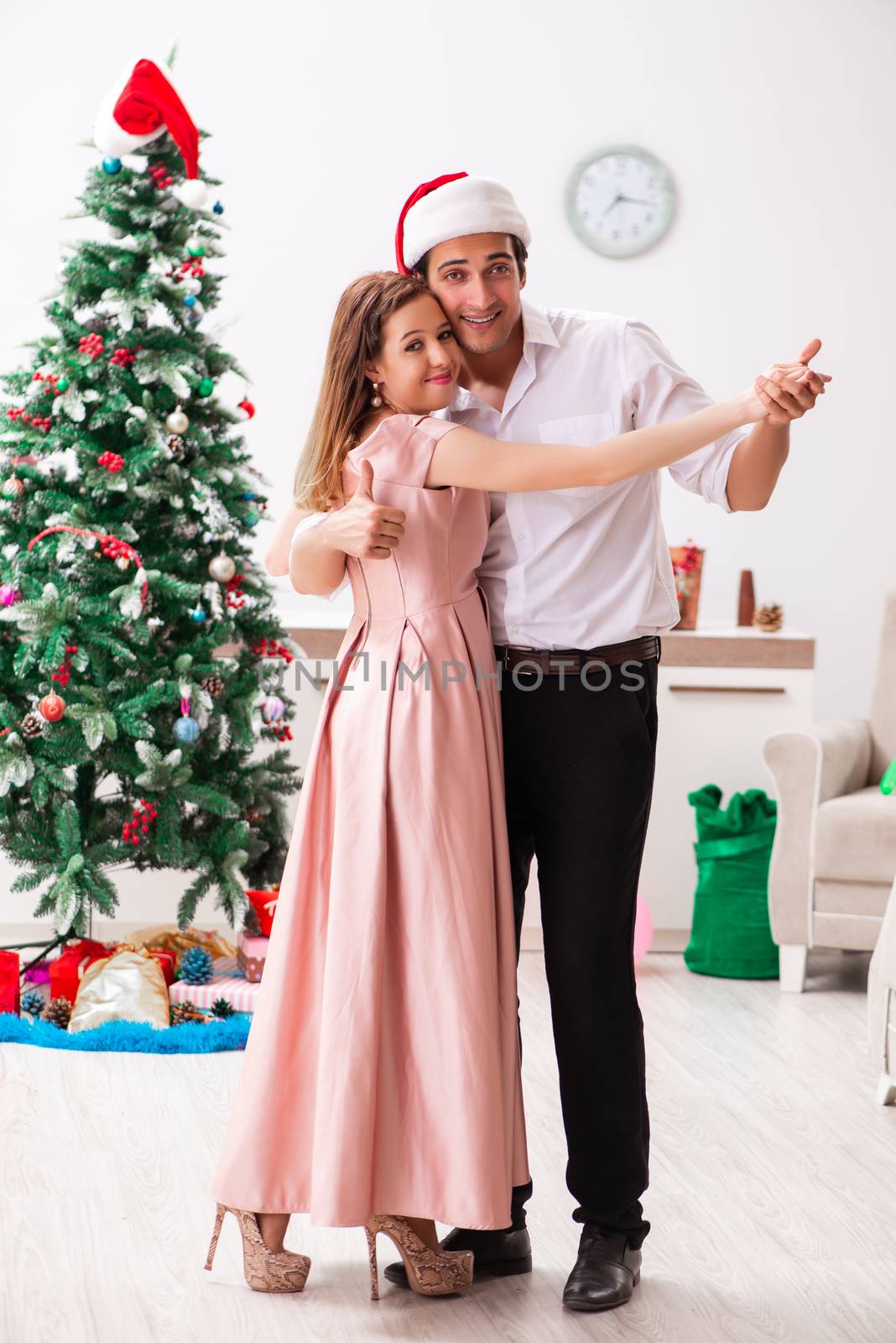 Young pair celebrating christmas at home
