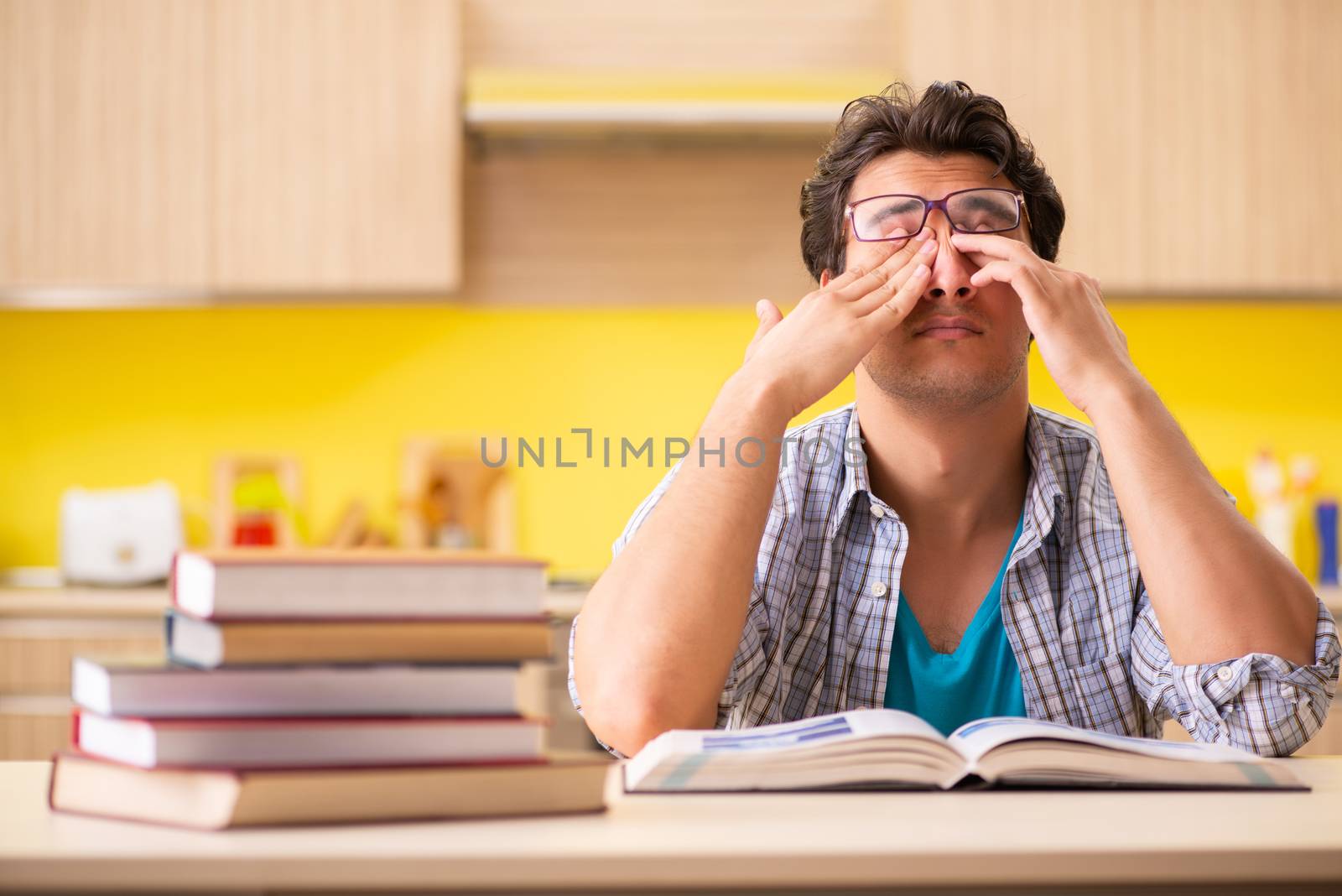 Student preparing for exam sitting at the kitchen 