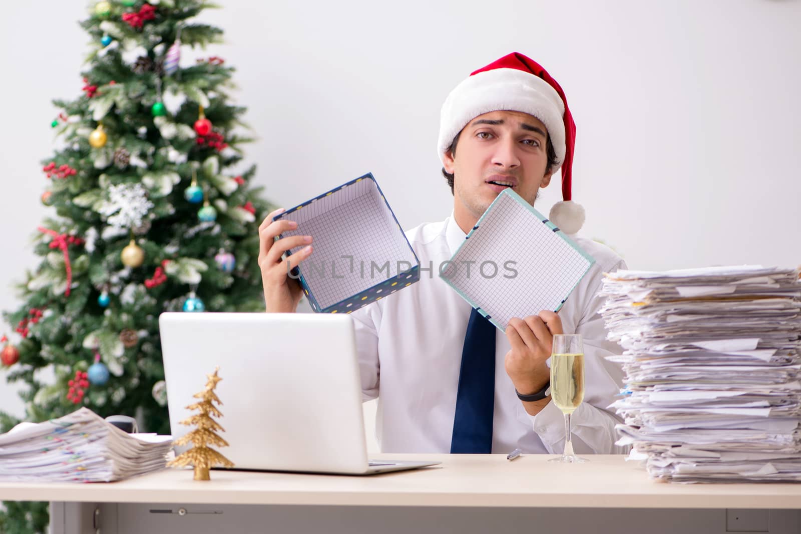 Young employee businessman in office christmas concept