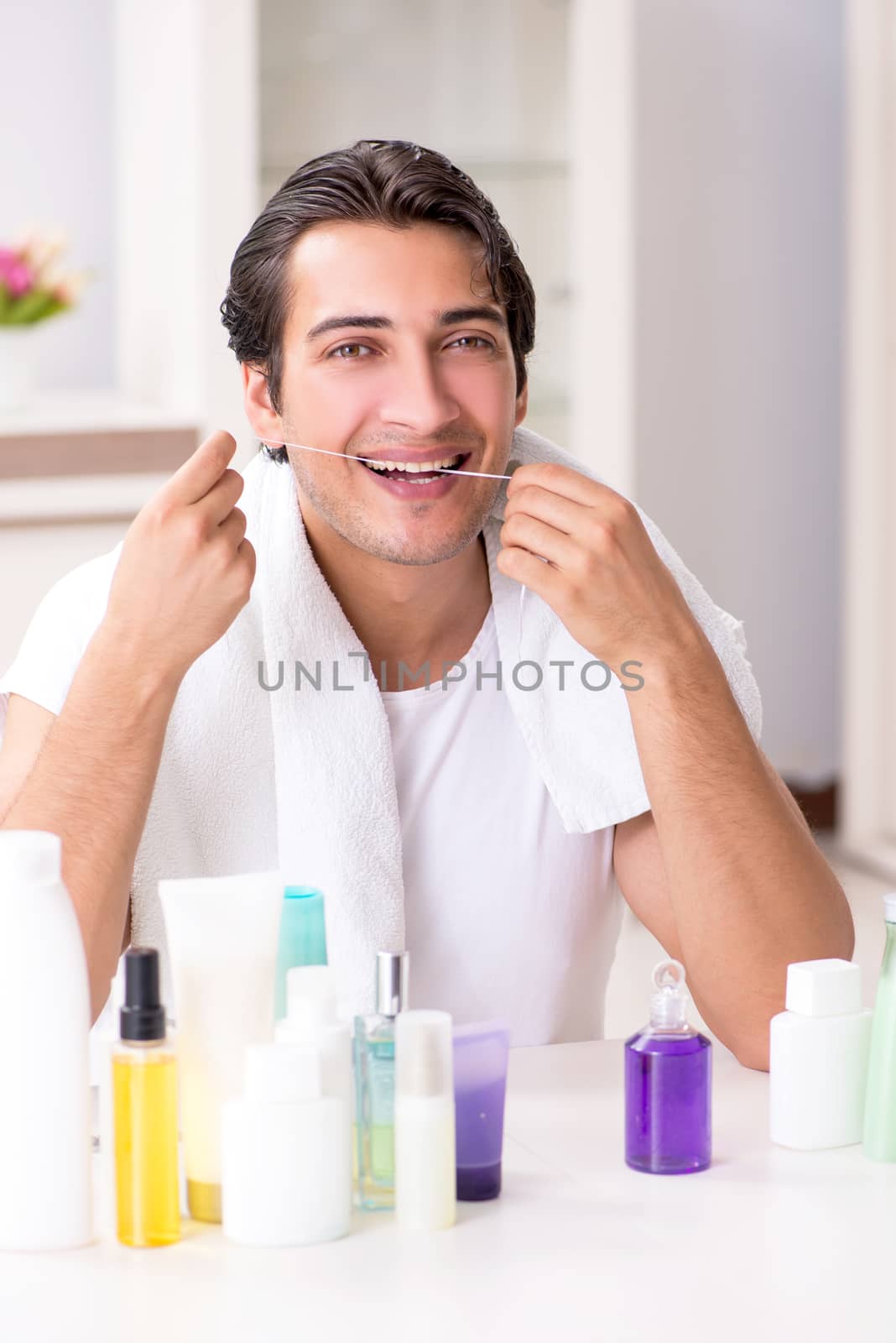 Young handsome man in the bathroom in hygiene concept  by Elnur