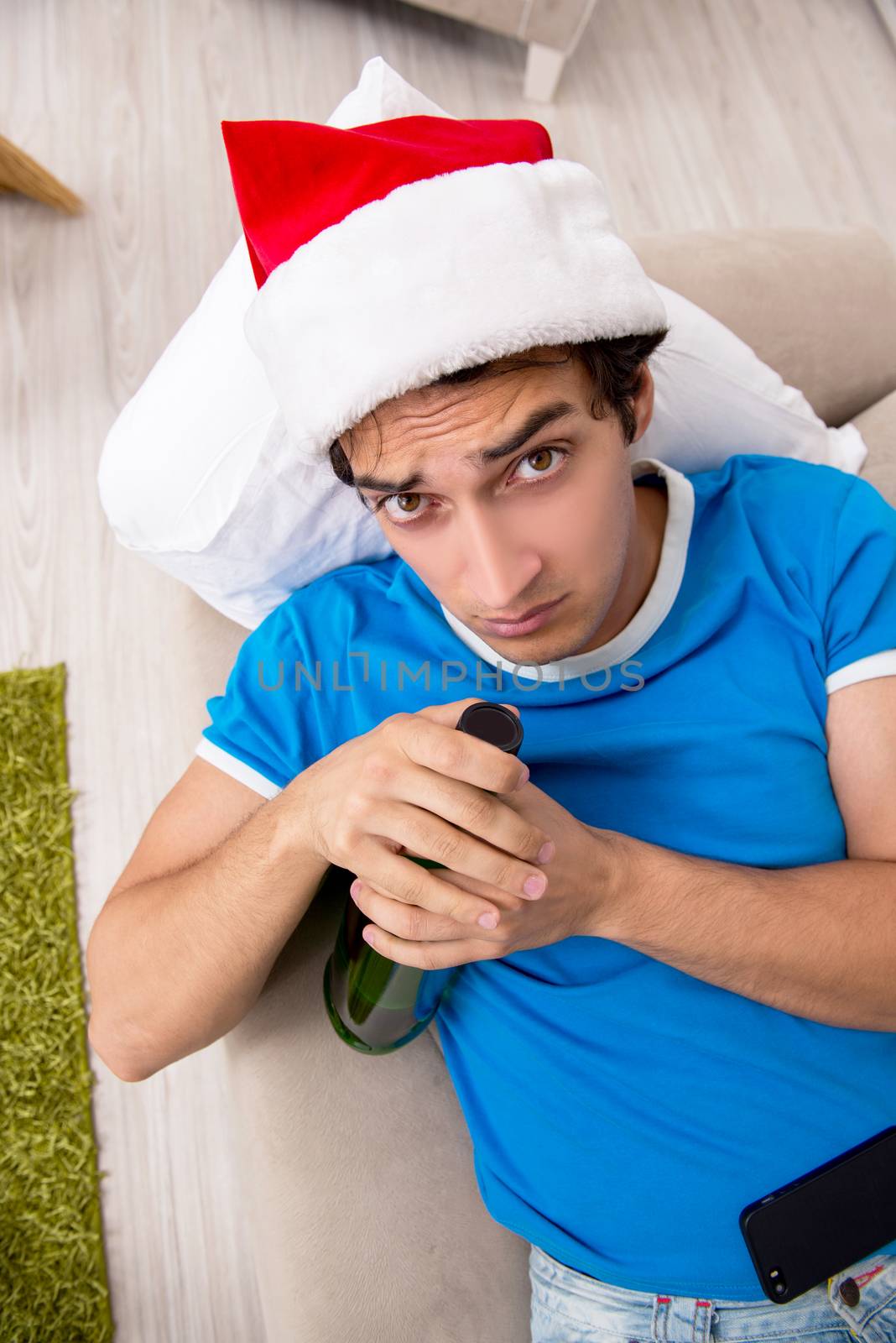 Young man drunk at home after christmas party by Elnur
