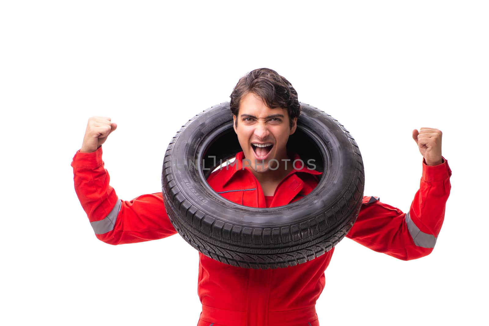Young garage worker with tyre isolated on white