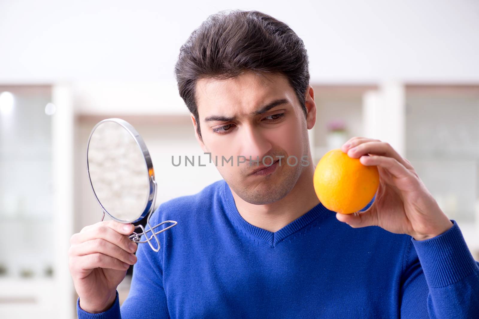 Young handsome man taking care of face skin
