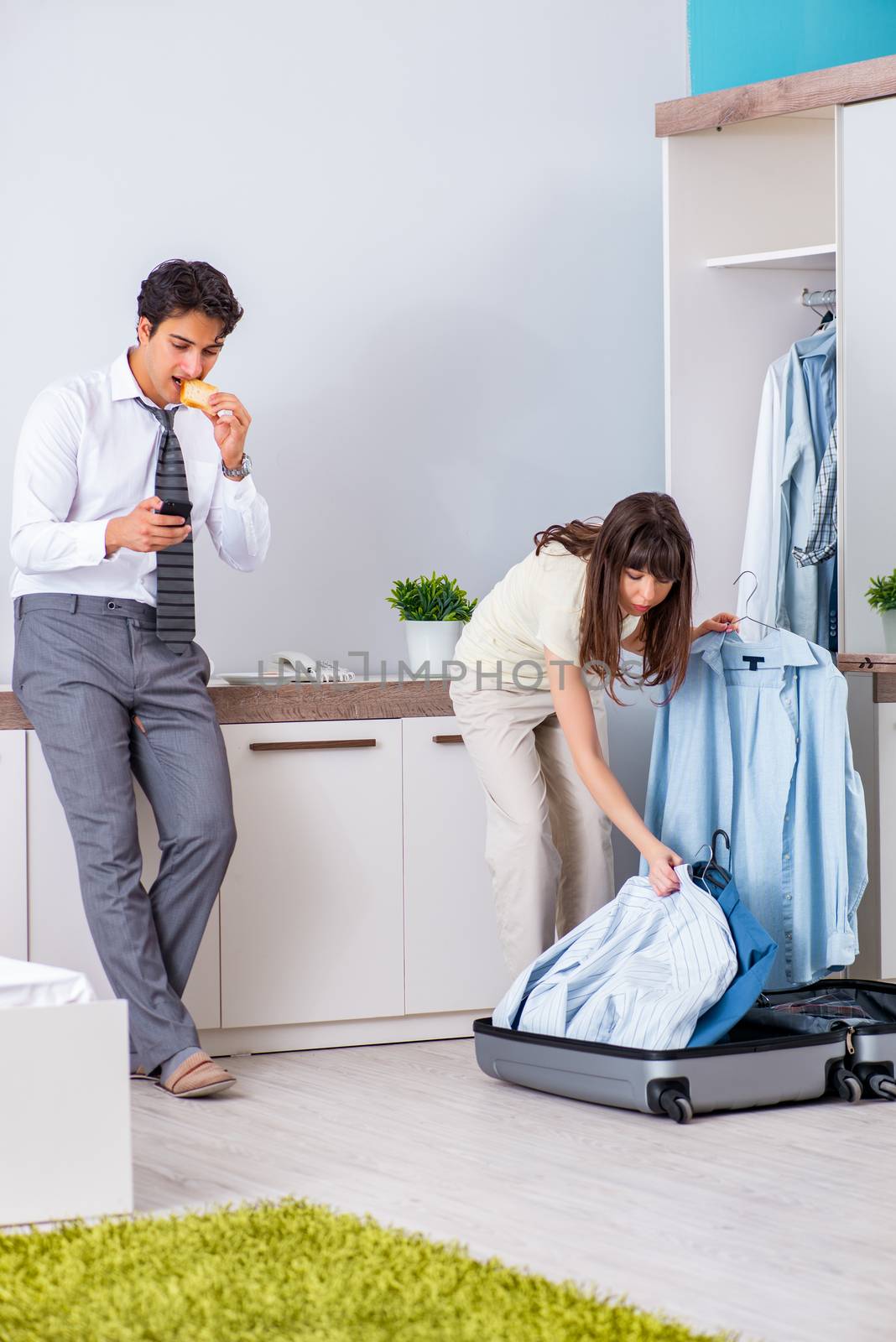 Wife seeing her husband off to business trip