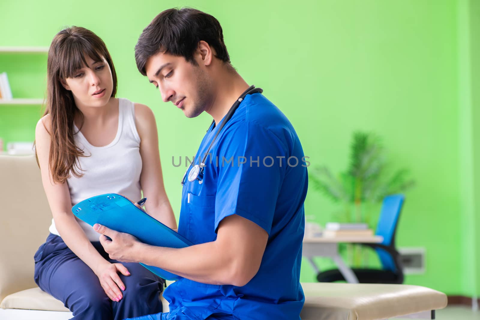 Female patient visiting male doctor in medical concept 