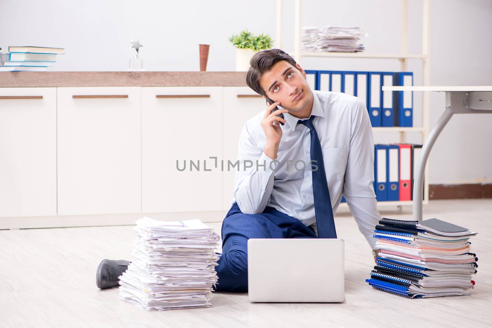 Extremely busy employee working in the office
