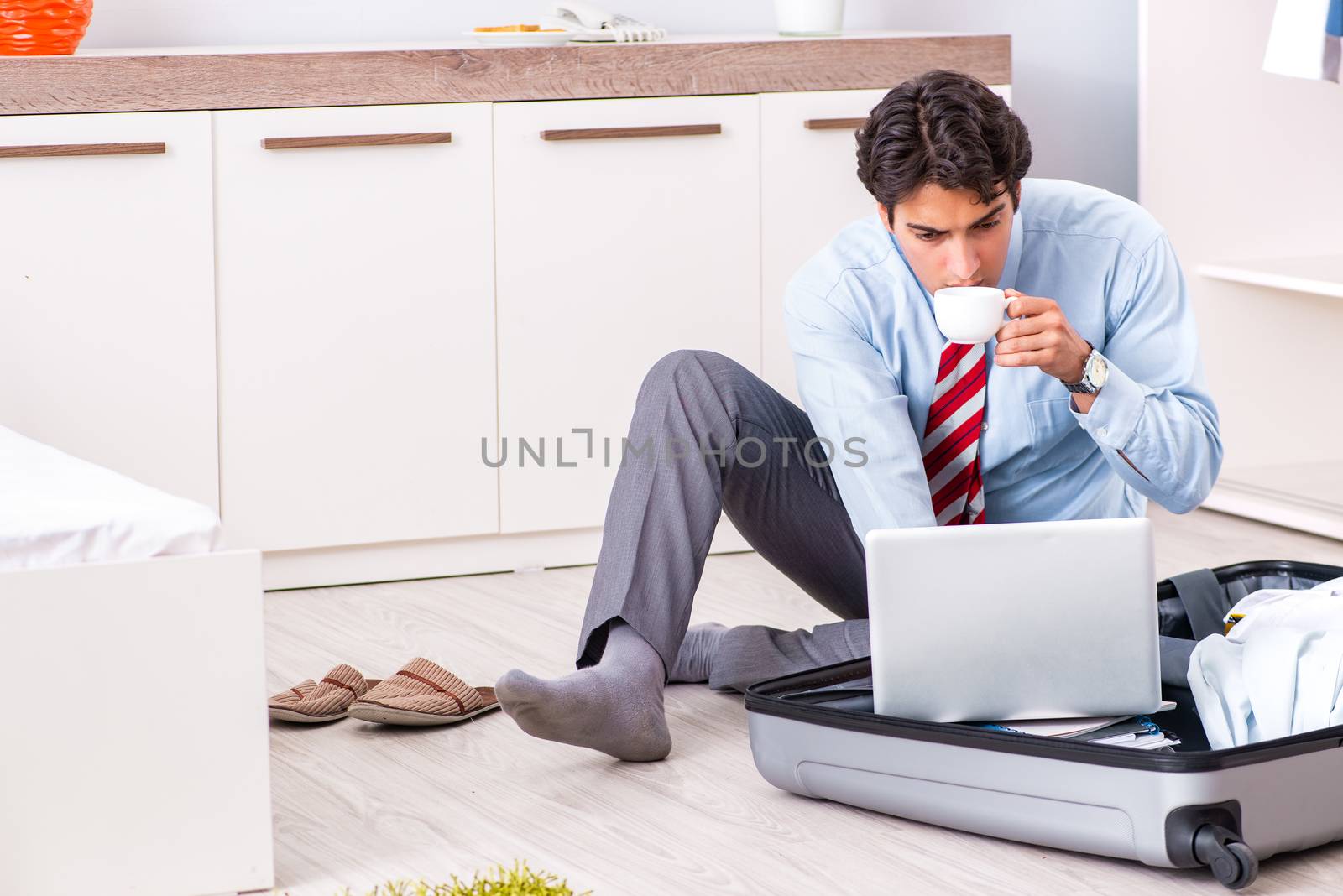 Young handsome businessman preparing for trip