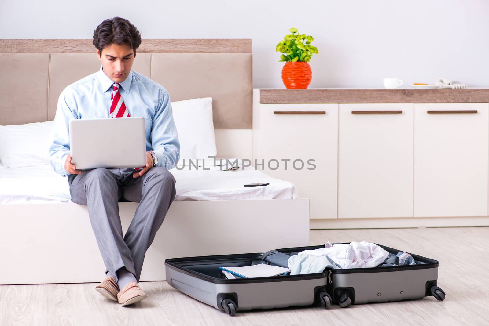 Young handsome businessman preparing for trip