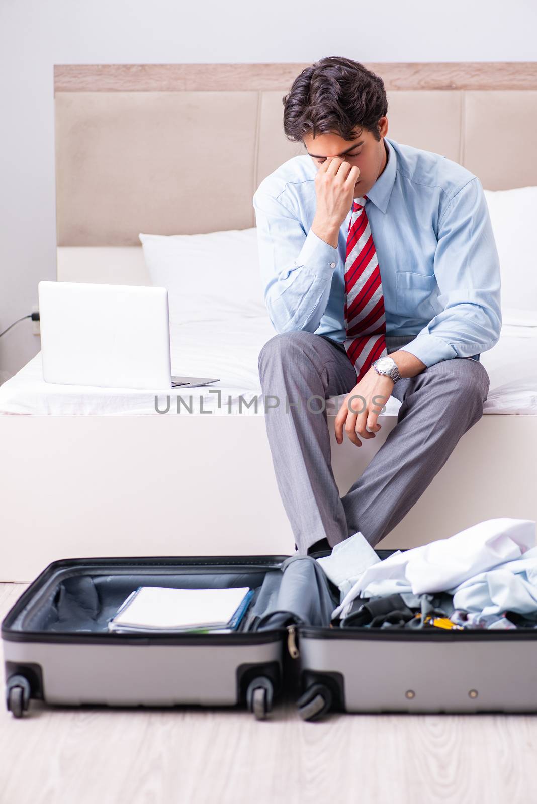 Young handsome businessman preparing for trip