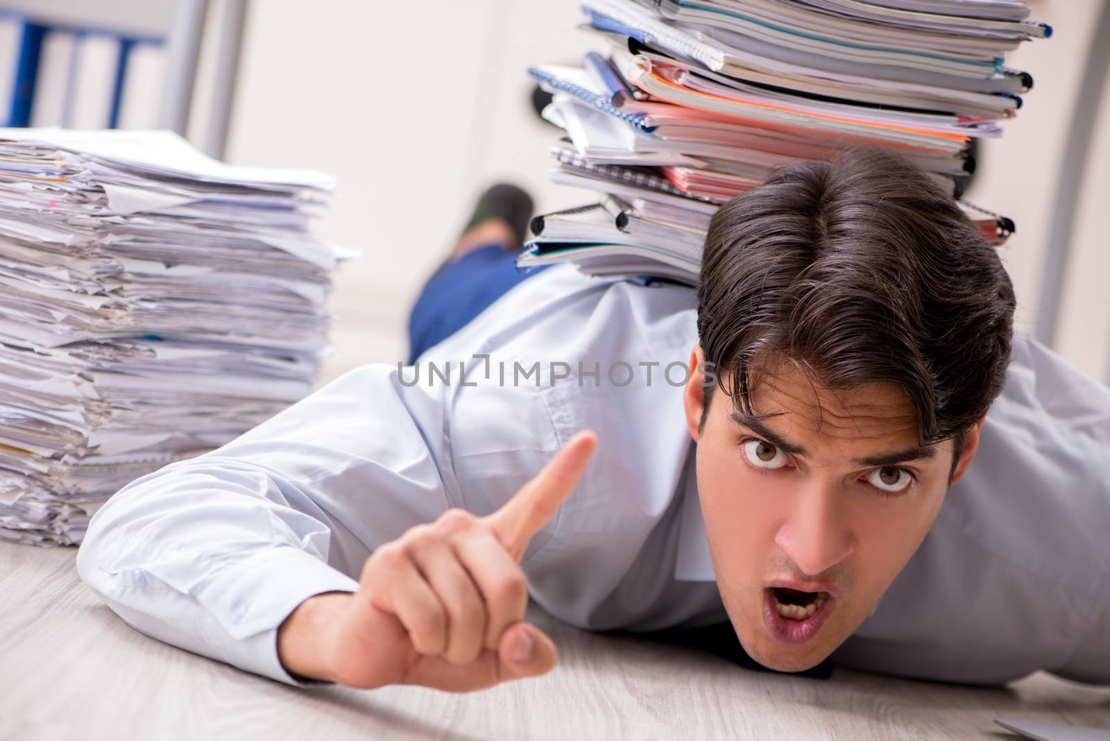 Extremely busy employee working in the office