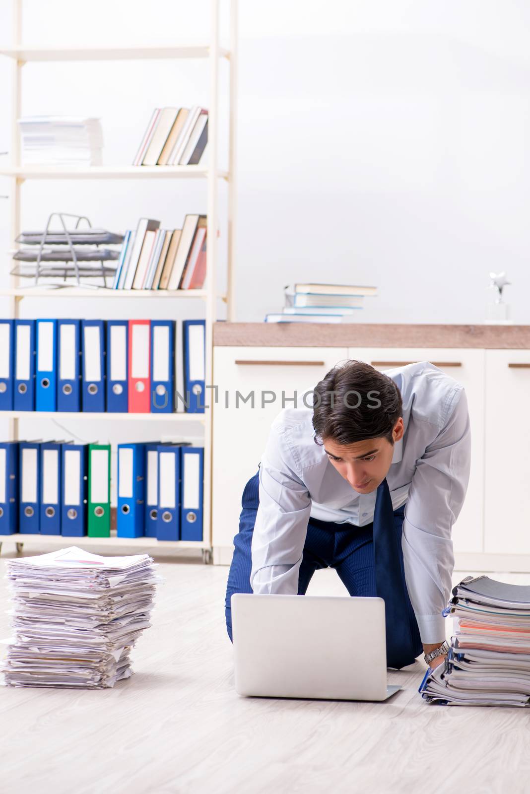 Extremely busy employee working in the office
