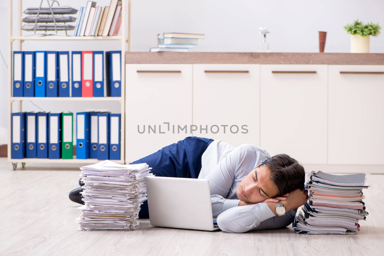 Extremely busy employee working in the office