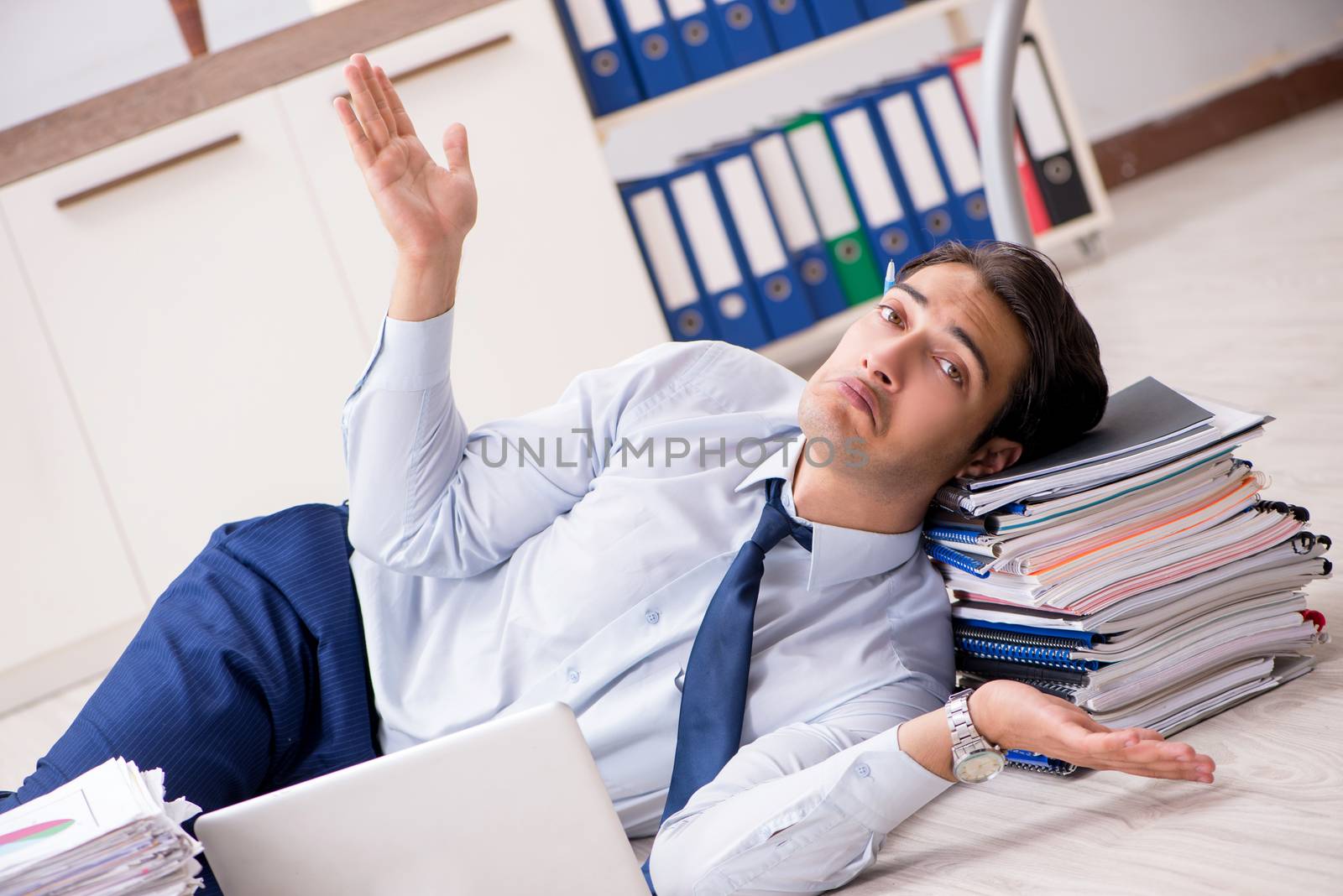 Extremely busy employee working in the office