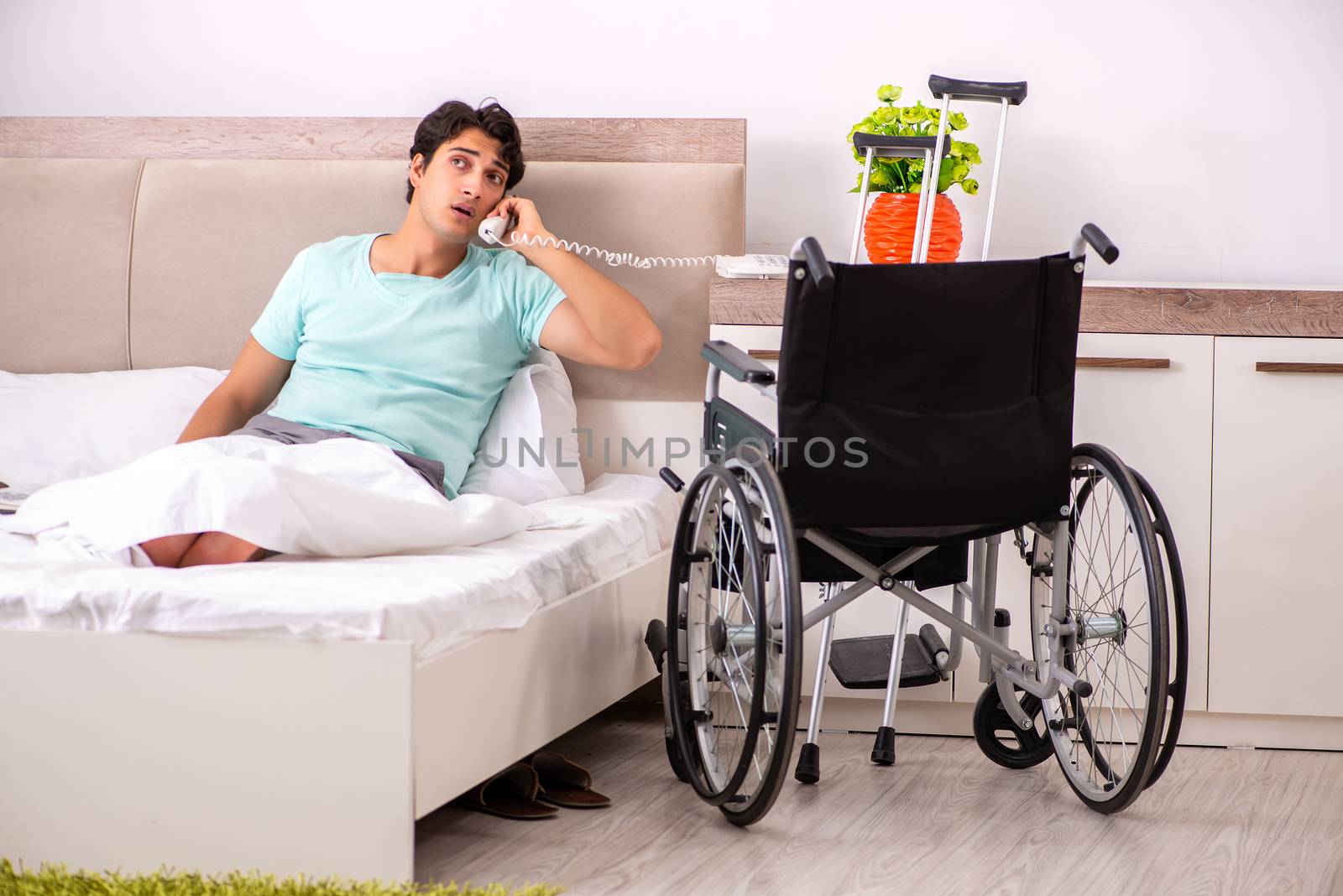 Young handsome disabled man recovering at home 