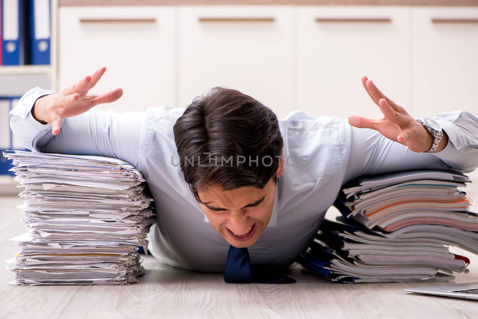 Extremely busy employee working in the office