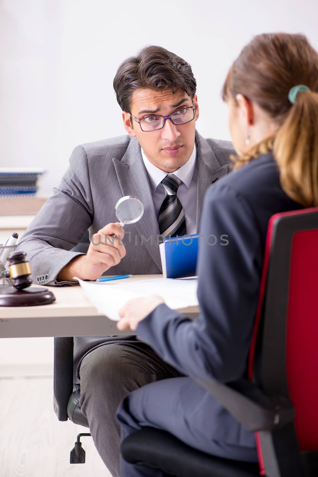 Lawyer talking to client in office by Elnur