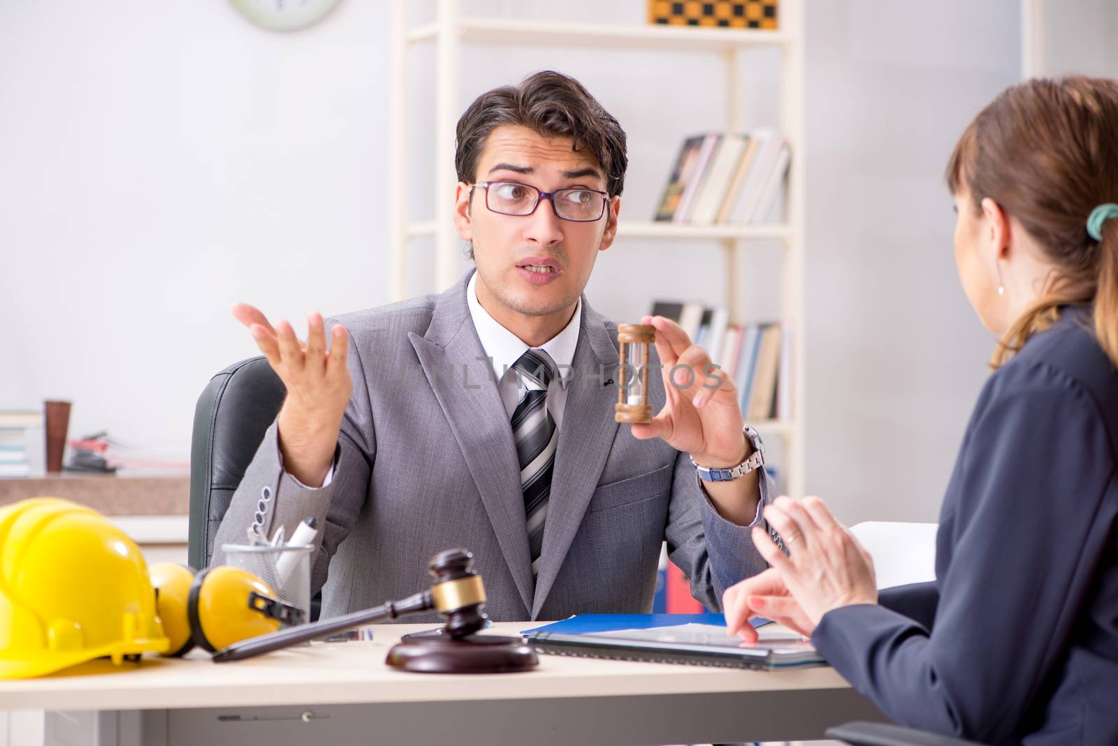 Lawyer talking to client in office