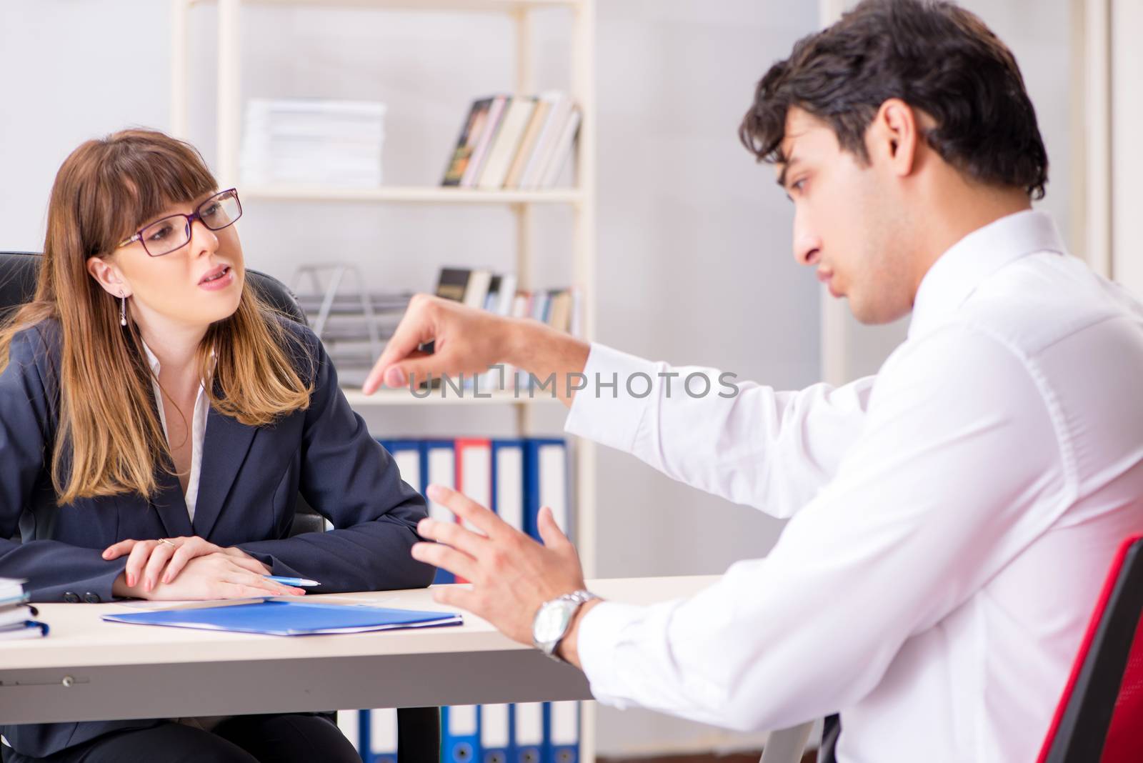 Man and woman discussing in office