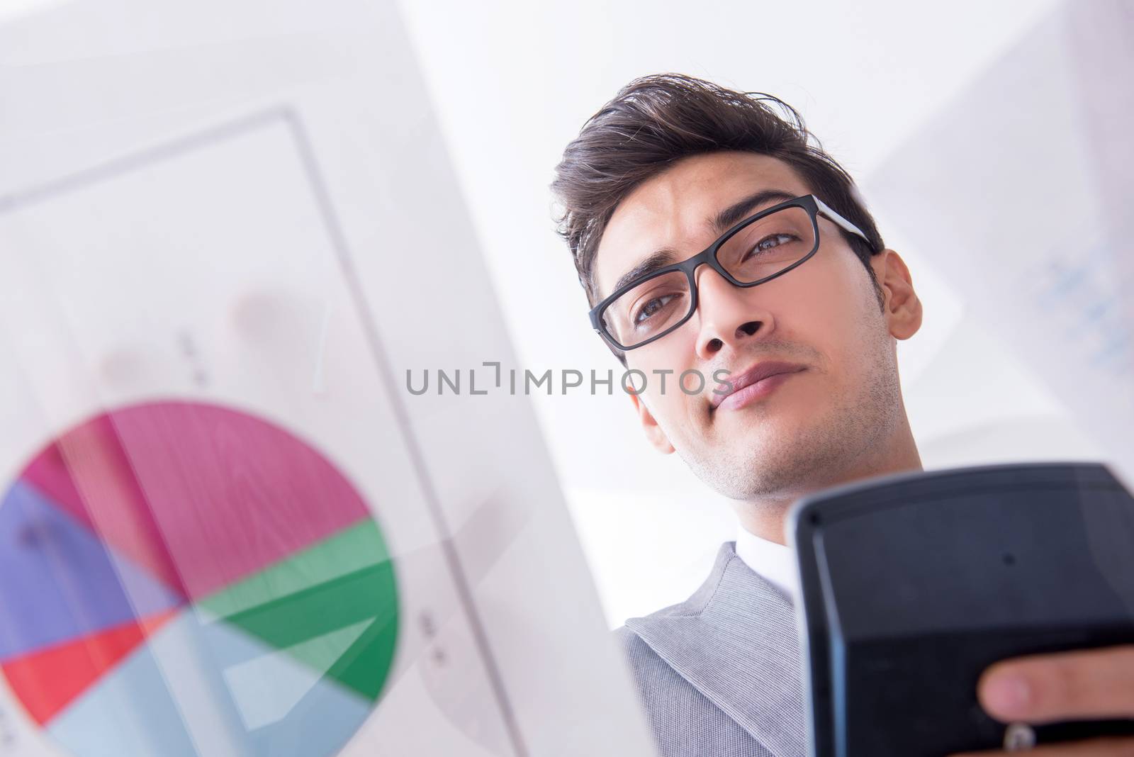 Businessman looking at financial charts and graphs