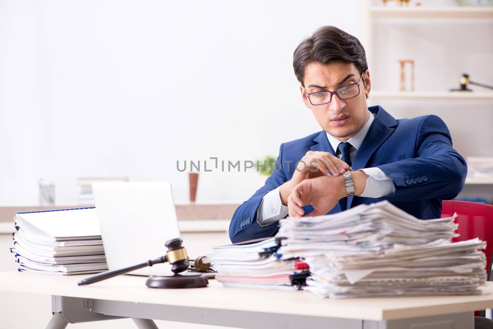 Young handsome judge working in court