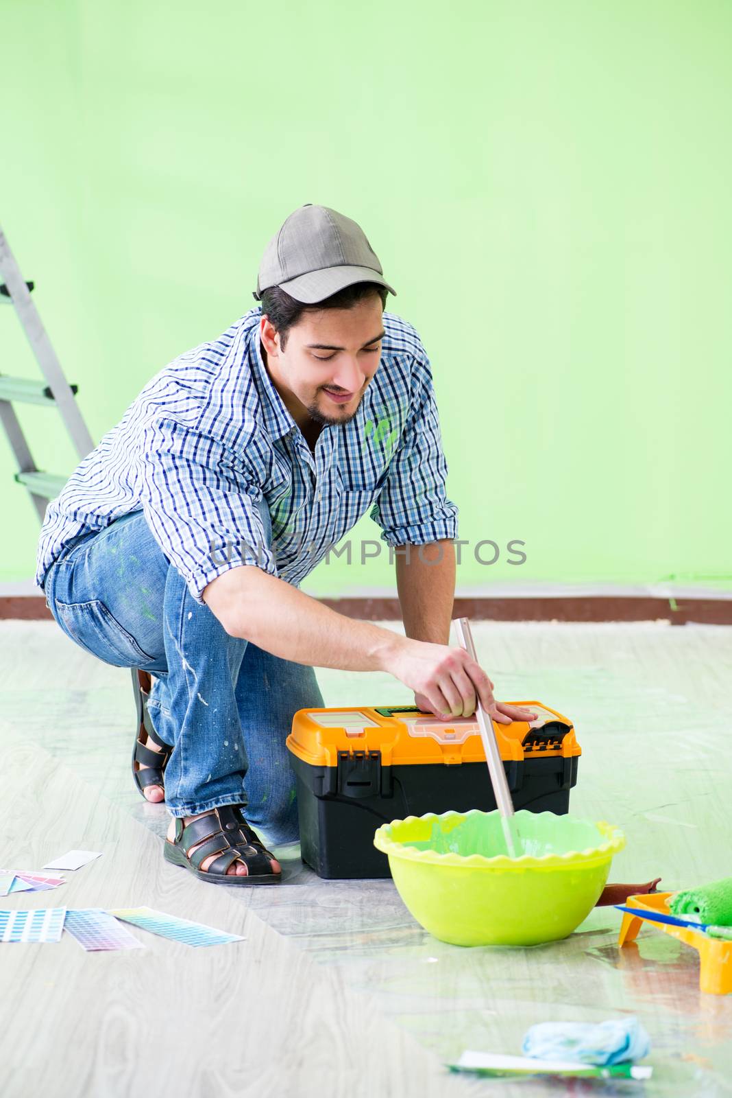 Young man doing home renovation  by Elnur