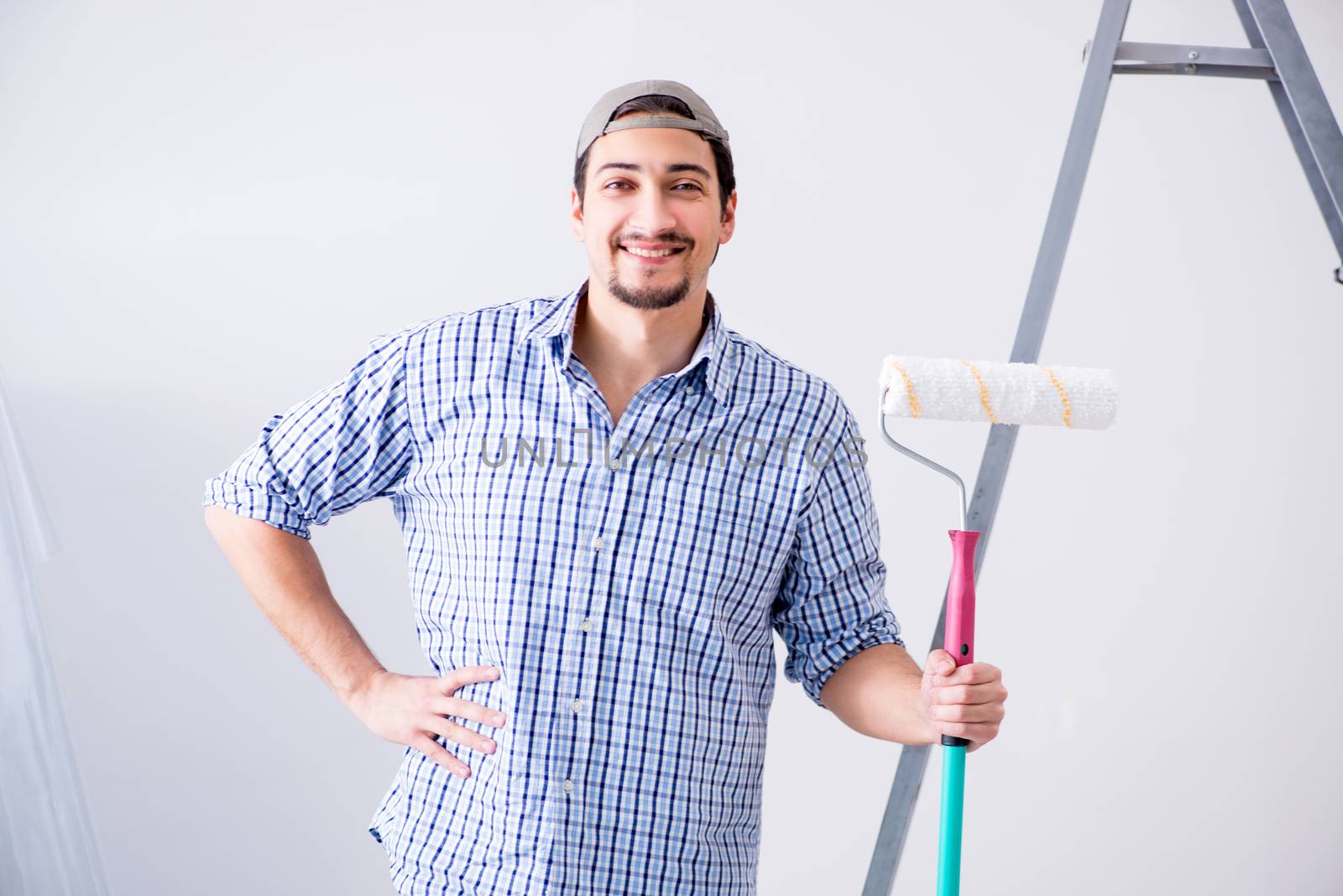 Young painter doing renovation at home 