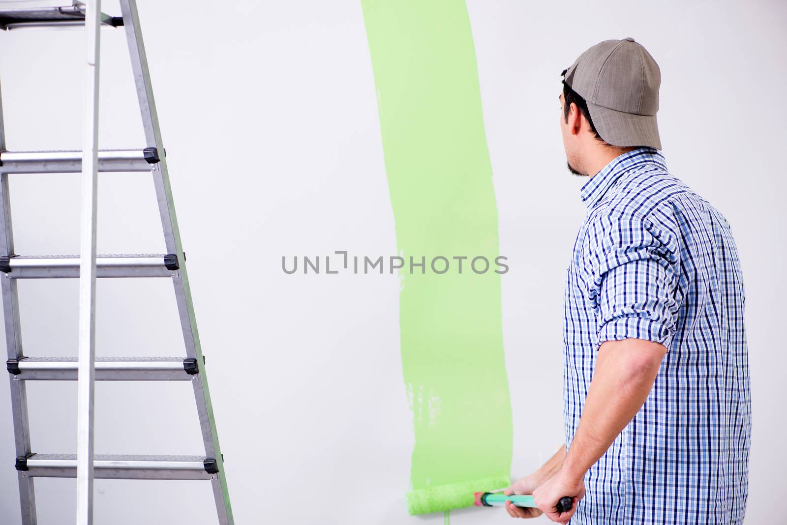 Young painter doing renovation at home 