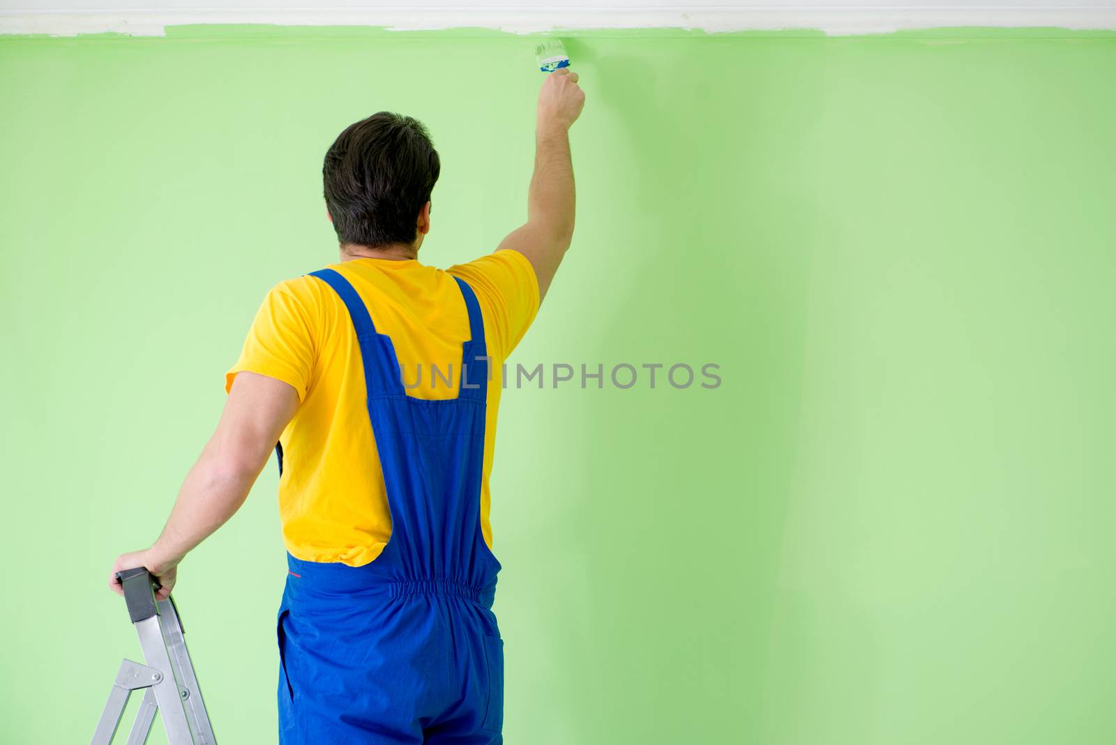 Young painter doing renovation at home 