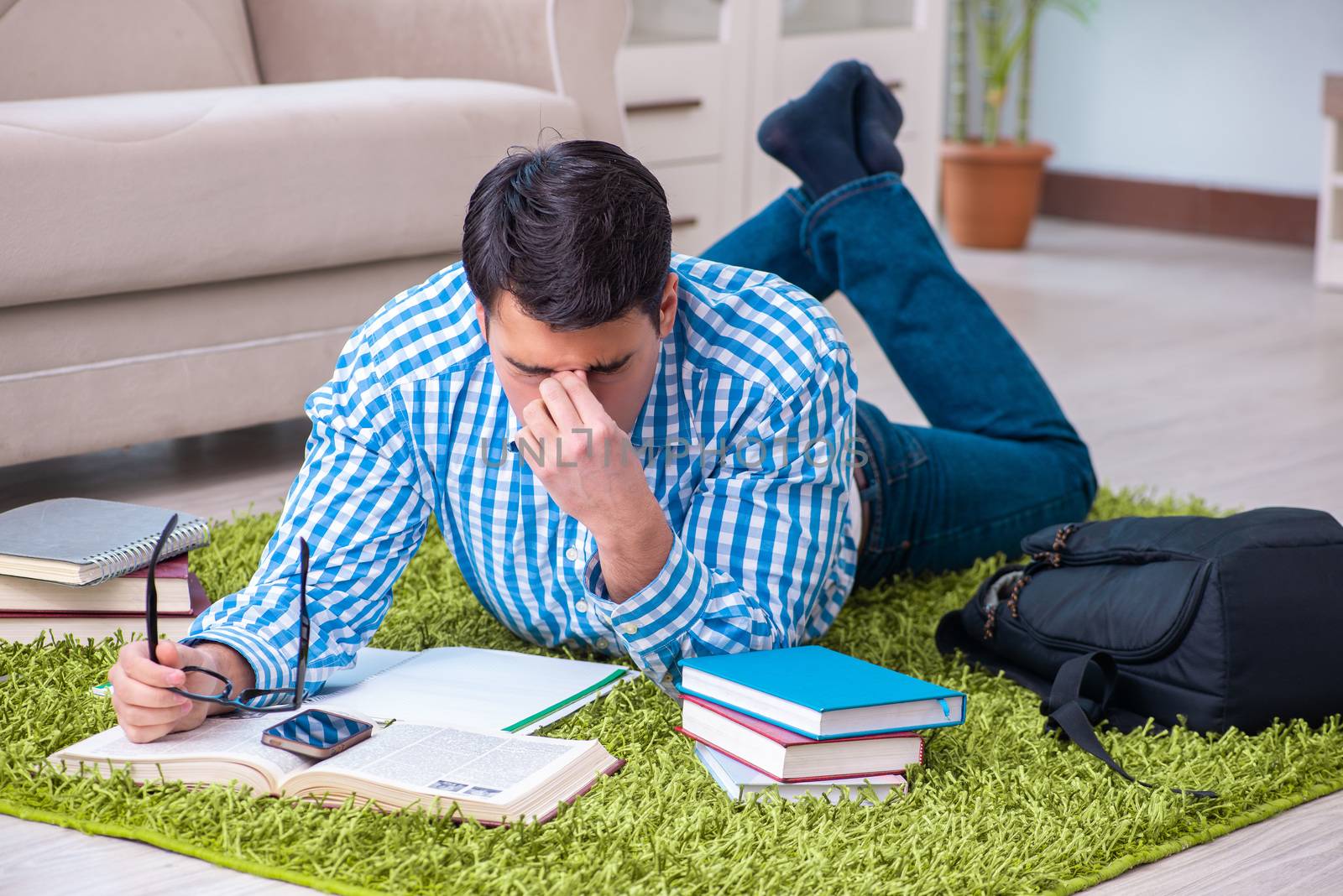 Young student preparing for exams at home