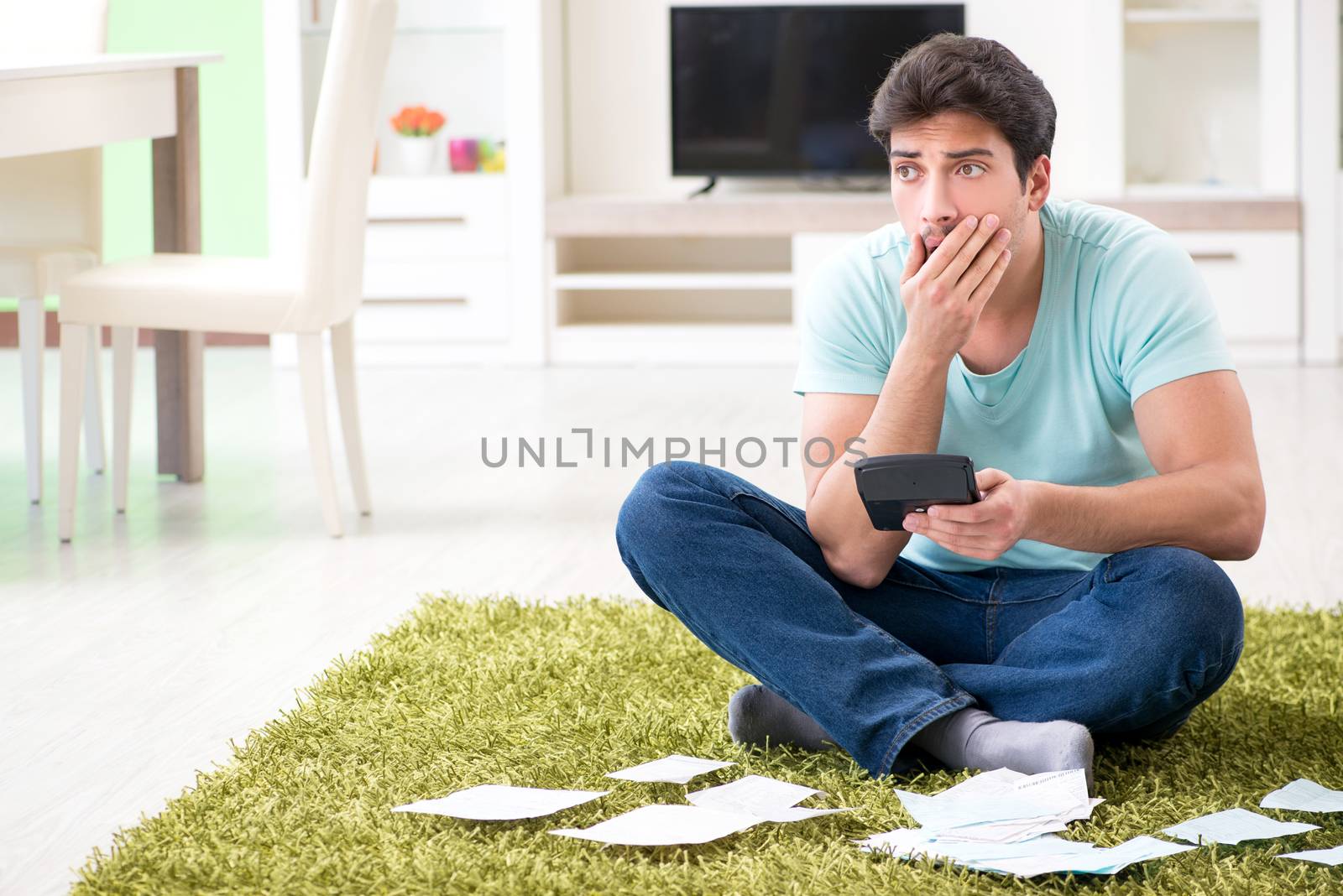 Young man struggling with personal finance and bills