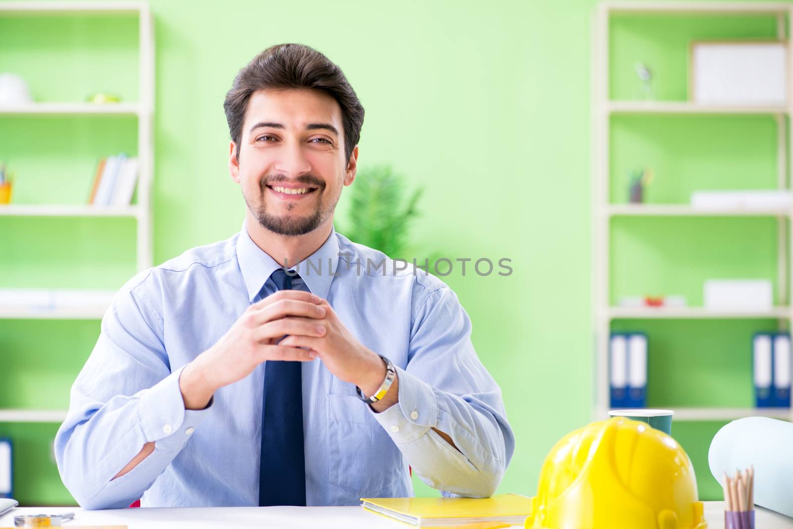 Young male architect working at the project
