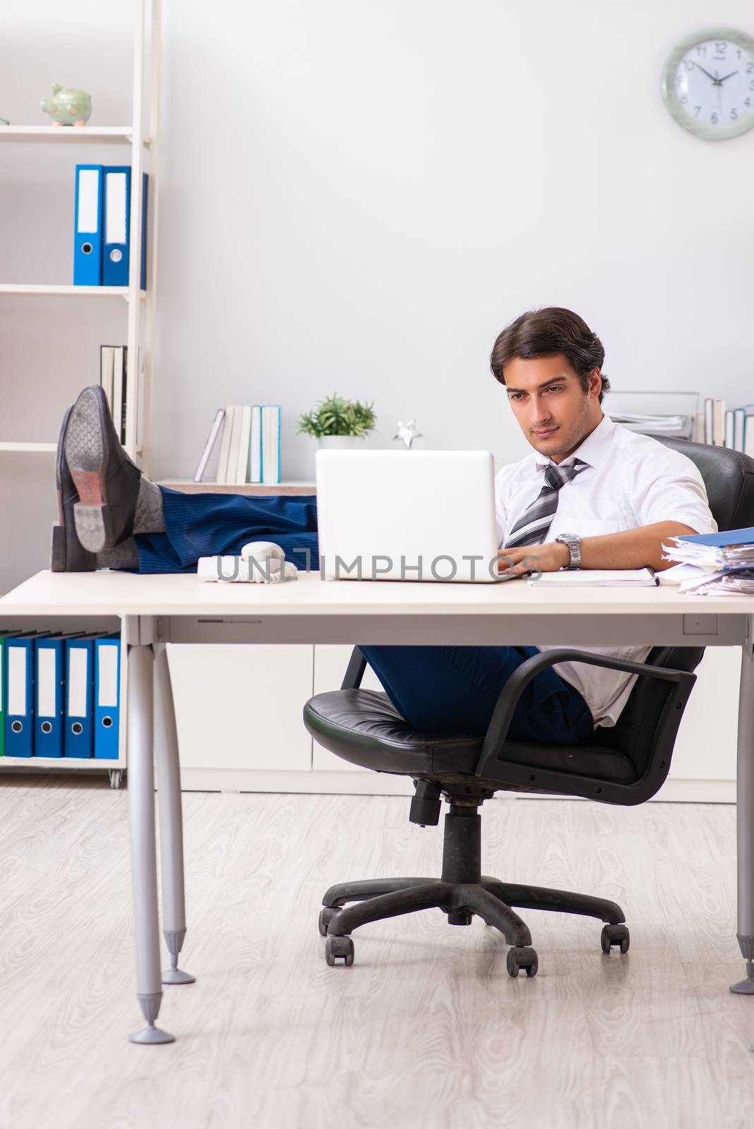 Young handsome businessman working in office by Elnur