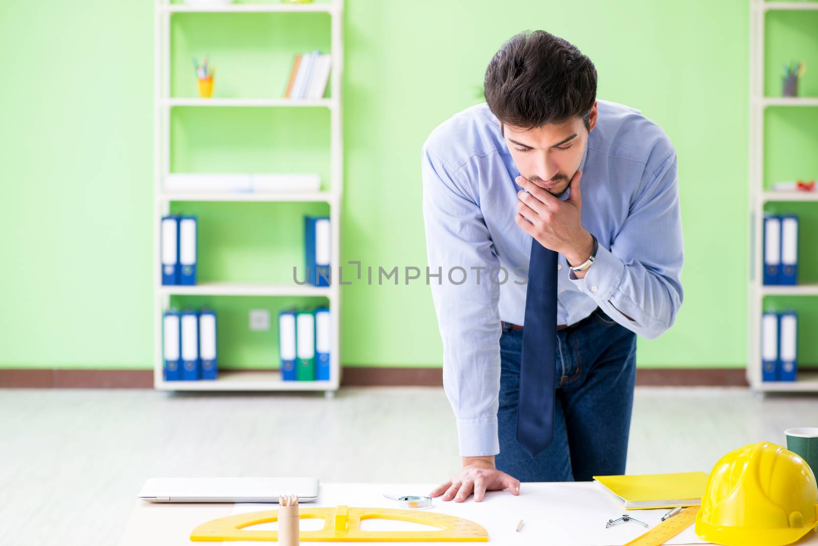 Young male architect working at the project