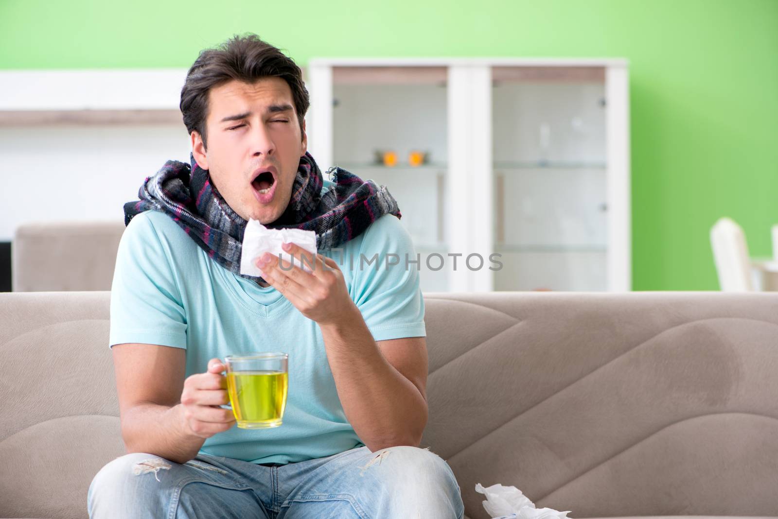 Young handsome man suffering from illness at home 