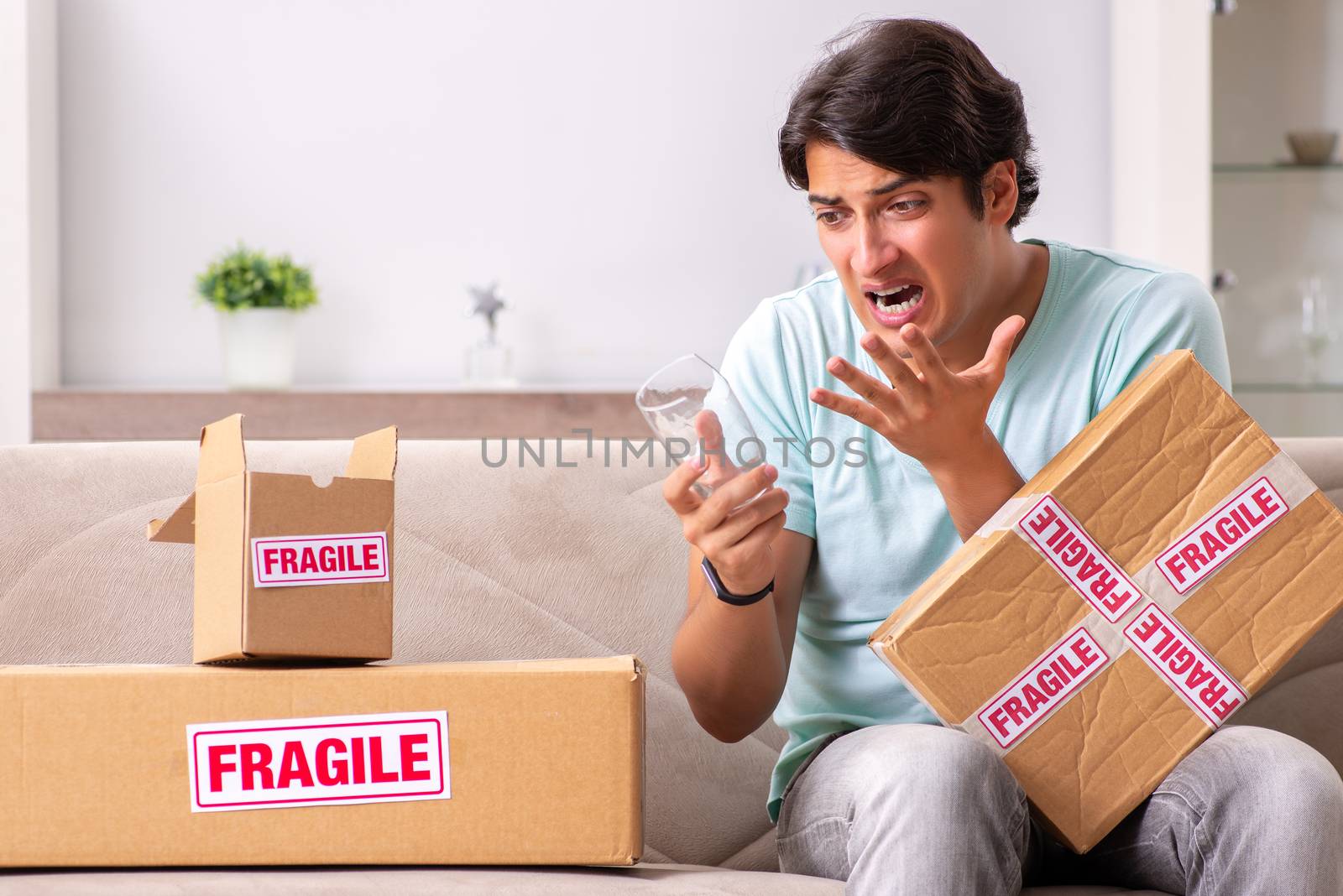 Man opening fragile parcel ordered from internet