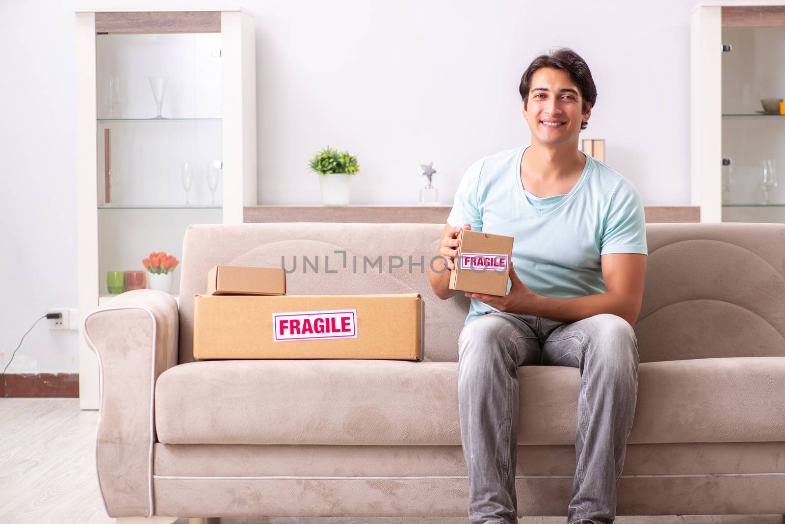 Man opening fragile parcel ordered from internet