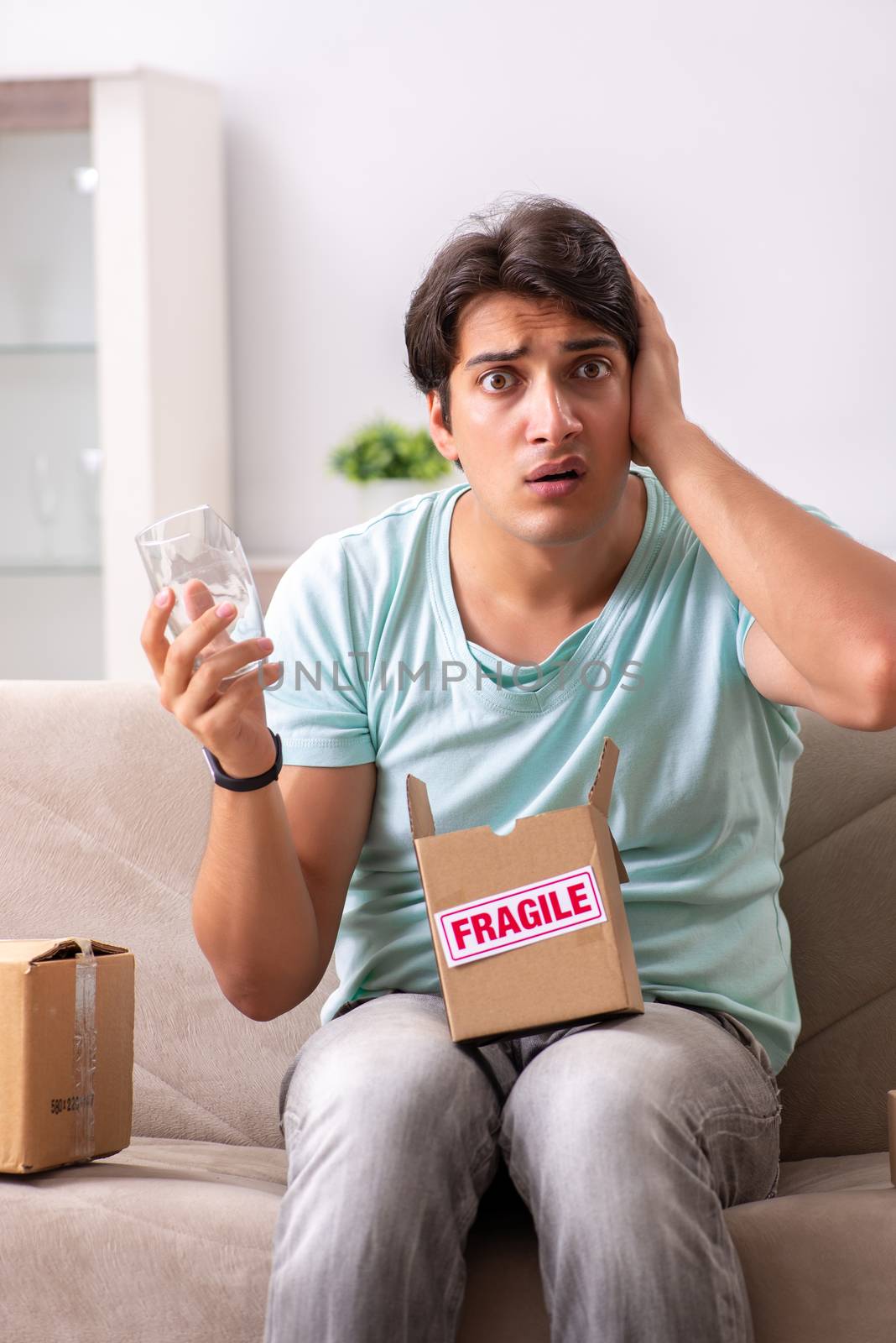 Man opening fragile parcel ordered from internet