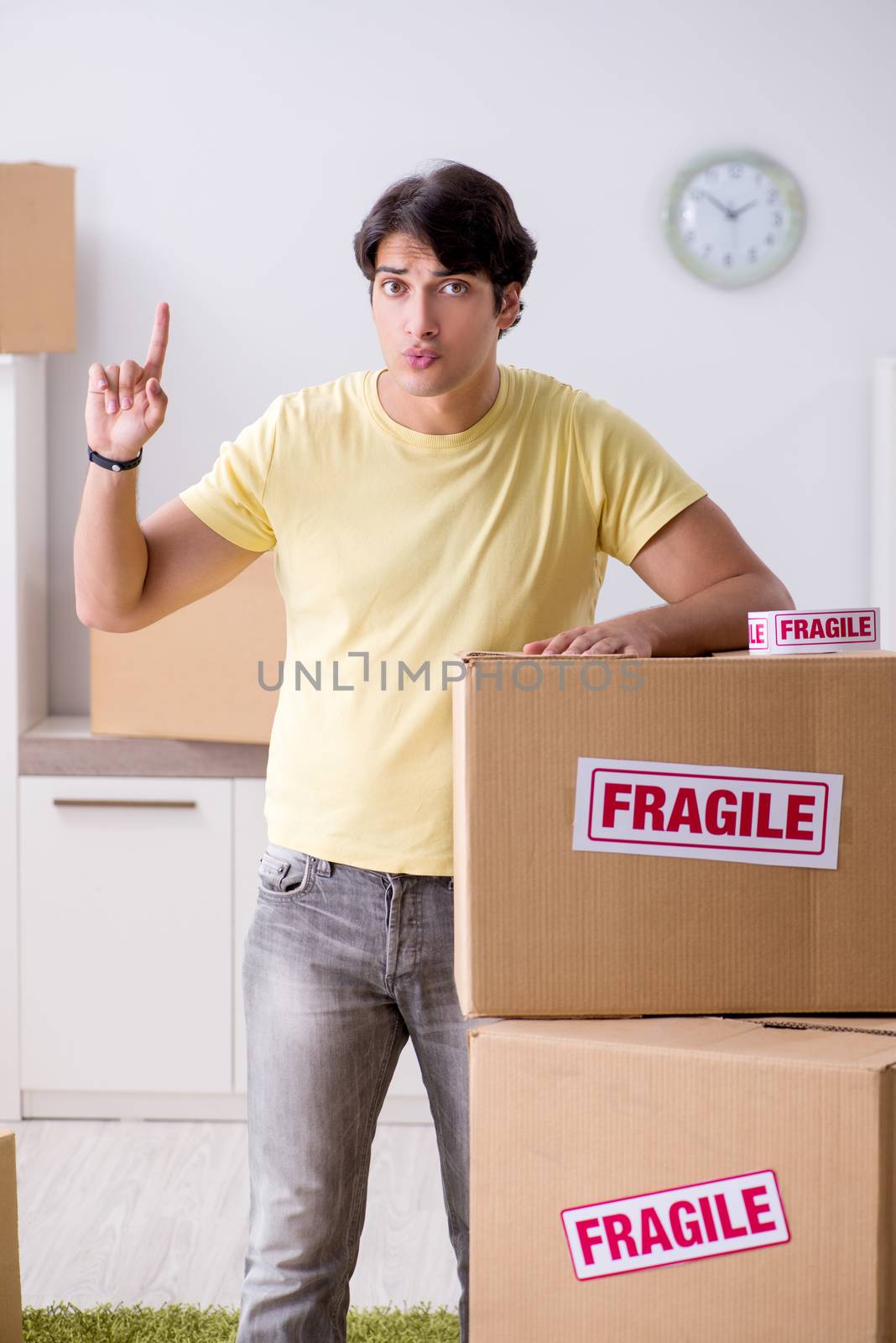 Man moving house and relocating with fragile items