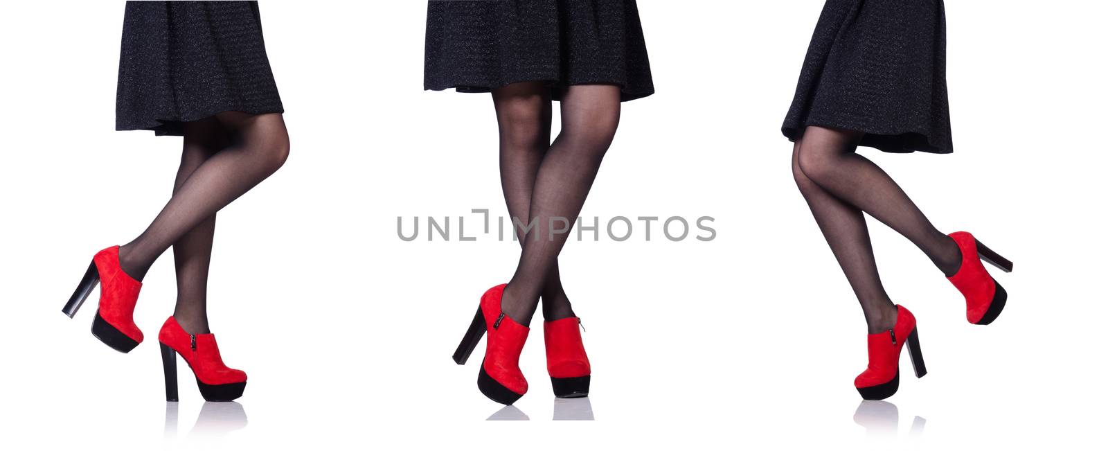 Woman legs with red shoes isolated on the white by Elnur